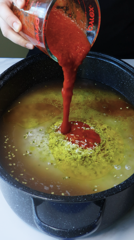 1. Add rinsed rice and mung beans to a large Dutch oven, then add water, beef broth, tomato sauce, oil, chickpeas, seasonings, and cilantro. 